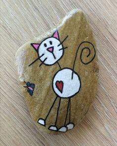 a rock with a cat painted on it