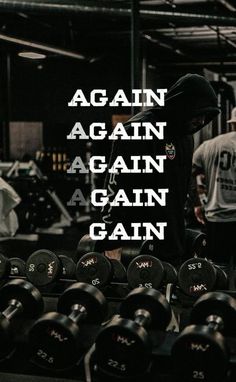 a man standing in front of a row of dumbbells with the words, again again again again again again again again again again again