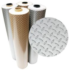 three rolls of metallic foil next to one roll of white paper with black dots on it