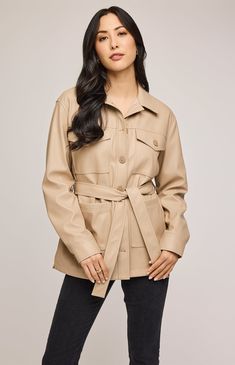 The Grenadine jacket is made of a soft faux leatherette and is fully lined for ease of wear. Features include patch pockets, side slits, and a removable belt for styling versatility. Beige Long Sleeve Outerwear With Belt, Beige Belted Outerwear For Fall, Belted Long Faux Leather Coat, Belted Faux Leather Long Coat, Belted Beige Outerwear For Office, Leather Jacket With Belted Cuffs, Utility Leather Jacket For Fall Workwear, Chic Leather Jacket With Faux Front Pockets, Classic Fall Outerwear With Belt