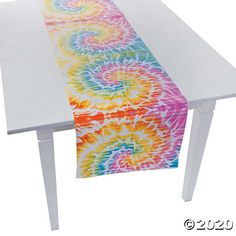 an image of a table runner with colorful swirls on the edge and white legs