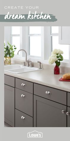 a kitchen with gray cabinets and white flowers in vases on the counter top, along with text overlay that reads create your dream kitchen