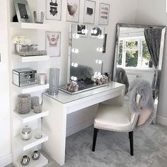 a white desk with a mirror and some pictures on the wall