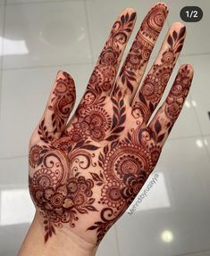 the hand is decorated with intricate designs on it