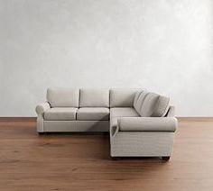 a white couch sitting on top of a wooden floor