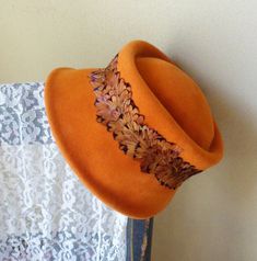 "This is a very lovely lady's orange velour hat from the 50's or 60's. It was made by the famous designer Riviera, in Italy. It's a cloche style hat with a band of feathers and an angled sun-deflecting brim. You'll love how this hat feels and looks. It's a must have for the lover of vintage French fashion. It's still in great condition and has a 20\" inner circumference. It shows no wear. Printed inside: \"Riviera, Finest Quality Imported Velour, Body Made in Italy\"" Vintage French Fashion, The Lover, Famous Designer, Famous Designers, French Fashion, Vintage French, Hat Designs, Hat Fashion, French Vintage