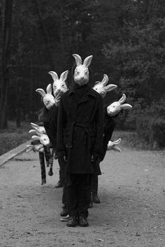 a person wearing bunny ears walking down a road