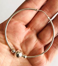 "Simple and classic Cape Cod style round solid sterling silver hoop earring ball beads. I assemble this earring with two 5mm and one 10mm sterling silver bead finish it with a 53mm endless hoop. Hoop dimension: 54mm (2 1/8\") hoop tube thickness: 2mm (3/32\") Bead size: 2 x 5mm and 1 x 10mm Quantity: 1 pair = 2 pieces stamped: 925 (marking of sterling silver) This earrings will send with a gift box. We are not affiliated with Eden Hand Art of Dennis, MA, the creator of the Cape Cod Jewelry." Hypoallergenic Sterling Silver Hoop Earrings With Round Beads, Hypoallergenic Silver Hoop Earrings, Silver Cape, Cape Cod Jewelry, Locket Ring, Sterling Silver Locket, Silver Lockets, Sterling Silver Hoop Earrings, Sterling Silver Hoops