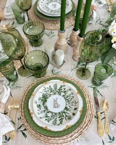 the table is set with green and white dishes