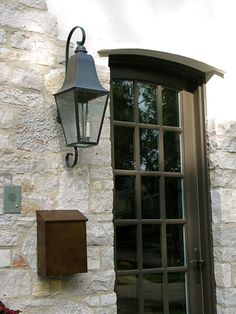 a light that is on the side of a building next to a door and window