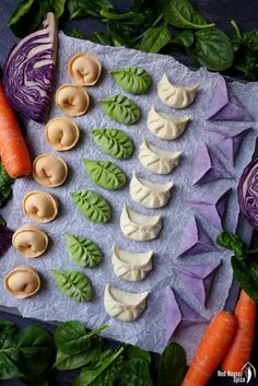 some food is laying out on a piece of paper next to carrots and broccoli