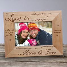 a wooden frame with a couple's photo and the words love is written on it