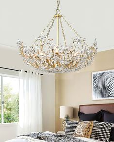 a chandelier hanging from the ceiling in a bedroom