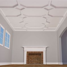 an empty room with a brick fireplace and white ceiling tiles on the walls, along with two windows