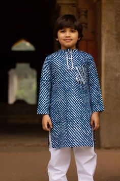 Be it festivities or a family gathering, dress your little boy in this exquisite, ethnic set. The set of 2 pieces, consisting of a blue leheriya kurta and white payjama, will give him an exquisite, yet comfortable look. From Lohri to Diwali, he will have an elegant look that will make him stand out. Kurta - Leheriya printed cotton kurta in a blue colour with gota decorated pocket. Payjama - White cotton payjama which is an easy wear as it comes with an elasticated waist. Floral print  Fabric - C Indigo Kurta For Navratri Festive Season, Indigo Festive Kurta For Navratri, Indigo Straight Kurta With Dabka, Indigo Kurta For Navratri, Festive Indigo Kurta For Navratri, Indigo Dabka Straight Kurta, Traditional Indigo Kurta With Dabka, Indigo Traditional Wear For Eid, Eid Festive Indigo Kurta