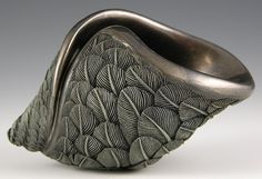 a silver ring with leaves on it