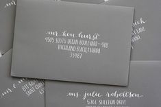 some gray envelopes with white calligraphy on them