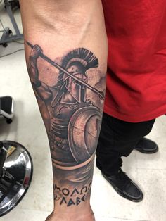 a man's arm with a roman soldier tattoo on it