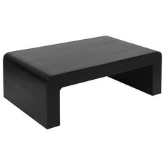 a black coffee table sitting on top of a white floor