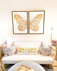 a living room filled with furniture and pictures on the wall above it's coffee table