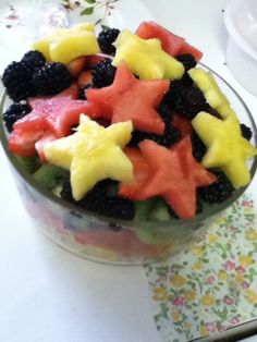 a bowl filled with fruit and stars on top of a table