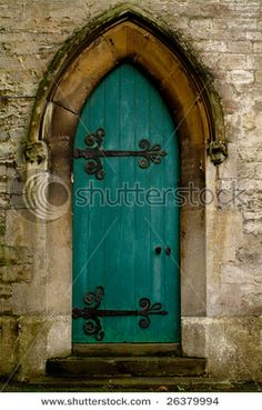 an old building with a green door and arched window