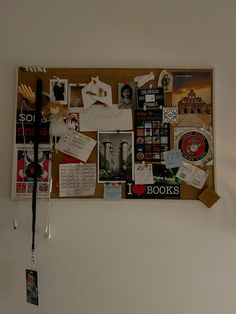 a bulletin board covered in lots of different items and tags hanging from it's sides