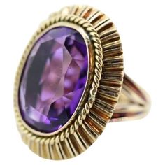 Vintage from the 1920s Size: 6.5 US Materials: Stone Gemstone: Amethyst Gem color: Purple Band Color: Purple Style: Art deco Magnificent Vintage Cocktail ring from the 20s, maybe earlier. Beautiful treasure. 14k Yellow Gold ring. Hand Made. Total weight 13.4 grams. Huge Oval cut Amethyst. Measured 20mm by 15mm by 10mm. Total estimated CTW is 16. Amethyst has shows some wear. Not seen when worn. All of our pieces are priced below appraisal and fair, but if you love a piece and would love to make an offer, don't hesitate. We at VoxMarket would appreciate and love your business. Cocktail Vintage, Wide Wedding Bands, 14k Gold Wedding Band, Amethyst Set, Purple Style, Green Amethyst Ring, Vintage Cocktail Ring, Style Art Deco, Gold Cocktail Ring