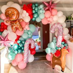 an entrance decorated with balloons and decorations for a baby's first birthday or other celebration