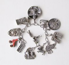 "A wonderful sterling silver bracelet with some stamped and some not stamped sterling silver and other metal charms. Big and small charms, chunky and changly! Bracelet is 6.5 inches long. Here are the charms: 1. Salzberg castle: stamped 800, .75 inches wide 2. Mexican trumpeter: no stamp, 1 inch tall (silver) 3. Ram: stamped Sterling, .50 inches 4. Deutschland : Stamped 800, 1 inch 5. Arc de triomphe: no stamp, .75 inches wide.25 inches wide (silver) 6. 1969 First Lunar LandingApollo 11: stamped Collectible Symbolic Charm Jewelry, Spiritual Silver Jewelry With Dangling Charms, Silver Vintage Charm Metal Charms, Silver Vintage Metal Charms, Silver Metal Charms With Vintage Detail, Antique Silver Metal Jewelry With Charms, Unique Nickel-free Silver Charm Bracelet, Unique Metal Charm Bracelet, Unique Silver Nickel-free Charm Bracelet