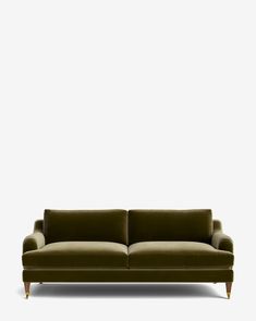 a green couch against a white wall with no one on it's legs or feet