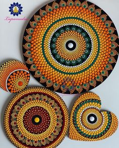 three circular designs made out of beads on a white surface