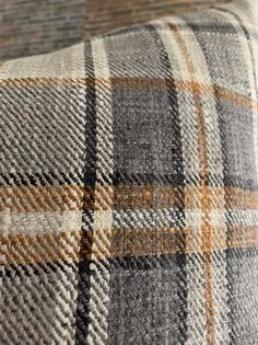 a close up view of a plaid pillow