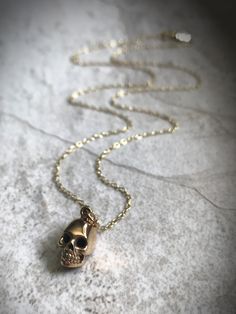 This necklace has a pendant of a realistic bronze skull, ready for spooky season! ***Now available in sterling silver!*** Comes on an adjustable 16-18" gold vermeil chain (14kt gold plated over sterling silver). Pendant is 1/2" long. Skull Jewelry Necklaces, Luxury Skull Shaped Necklace For Gift, Luxury Skull Necklace For Gift, Luxury Handmade Skull Jewelry, Silver Skull Necklace, Vintage Skull Necklace For Gift, Gold Skull Necklace, Gold Skull Jewelry Collectible, Gold Raven Skull Necklace