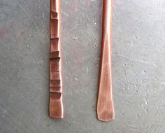 two wooden utensils sitting on top of a table