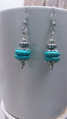 This is just a cute dangle earring that was fun to make and will dress up a casual outfit as well as business attire.  They feature two turquoise howlite stone disks, silver tone bead caps, silver tone metal bead and silver tone glass seed beads.  Silver tone findings complete the total look.  The earrings are approximately 2" long from top of ear wire to bottom of bead and include silicone stops to prevent loss.  The earrings in the photo are the exact pair you will receive.  Designed and handcrafted by me for you in my smoke free home studio. Carefully packaged and shipped in a white box enclosed in a bubble lined envelope.  Free shipping is USPS First Class Package with tracking.  Estimated delivery is 2-5 days. No returns accepted but please contact me should there be a problem with yo Turquoise Beaded Dangle Earrings For Gift, Turquoise Earrings With Silver Beads, Turquoise Dangle Beaded Earrings For Gift, Turquoise Earrings With Silver Round Beads, Adjustable Turquoise Earrings With Faceted Beads, Jewelry Making Earrings, Howlite Stone, Jade Earrings, Turquoise Howlite