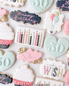 decorated cookies are arranged in the shape of heart, birthday cake, and number 50