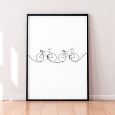 a black and white poster with three bikes on it in front of a wooden floor