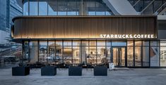 the outside of starbucks's coffee shop at dusk