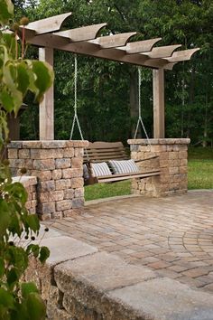 a wooden bench sitting on top of a stone patio