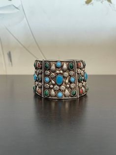 This vintage Navajo bracelet is filled with blue turquoise, green turquoise, coral and a whole lot of creativity and style set in sterling silver. This bracelet is large2 inches wide and wears like an 8-8.5 inch bracelet. it weighs 108.2 grams of silver. Get your statement bracelet on!! Silver Southwestern Cuff Bracelet With Natural Stones, Bohemian Turquoise Sterling Silver Bracelet, Bohemian Blue Sterling Silver Bracelet With Natural Stones, Southwestern Turquoise Multi-stone Bracelets, Collectible Bohemian Turquoise Bracelets, Bohemian Turquoise Bracelets Collectible, Bohemian Turquoise Collectible Bracelets, Collectible Bohemian Turquoise Bracelet, Turquoise Sterling Silver Bohemian Bangle