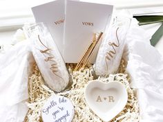 two personalized wedding favors in a gift box with some writing on the front and side