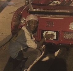 a man sitting on the hood of a fire truck