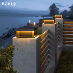 an architectural rendering of the exterior of a modern home at night with lights on and in front of water