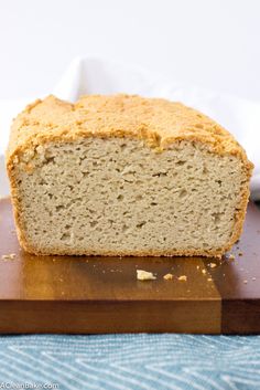 a loaf of bread sitting on top of a wooden cutting board