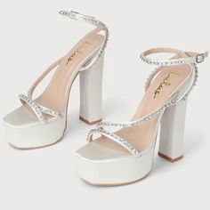 Sinia Ivory Satin Rhinestone Wrap Platform High Heel Strappy Sandals ~ Stilettos ~ Wedding ~ Bridal ~ Formal ~ Dancer ~ Homecoming ~ Party New! Retail Price - $69 Color - Ivory Satin Size - 9 5.5” Wrapped Block Heel 1.75” Platform Cushioned Insole Rubber Sole Has Nonskid Markings Sleek Satin Shapes These Statement-Making Heels That Have A Square Toe Footbed Atop A 1.75" Toe Platform. Clear Rhinestones, In Silver Settings, Adorn The Toe Strap, Vamp Strap, And The Matching Wrapping Ankle Strap Tha Glamorous White Sandals For Prom, Cream Embellished Heels For Summer, Summer Embellished Cream Heels, Party Cream Embellished Heels, Cream Embellished Party Heels, White Satin Platform Heels, Cream Rhinestones Party Heels, Cream Rhinestone Party Heels, Party Heels With Silver-tone Hardware