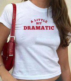 "𝑨 𝒍𝒊𝒕𝒕𝒍𝒆 𝒃𝒊𝒕 𝑫𝒓𝒂𝒎𝒂𝒕𝒊𝒄" Soft Tee Show your (little bit of) drama with this trendy and stylish tee. At 𝑴𝒚𝑺𝒉𝒊𝒓𝒕𝑺𝒂𝒊𝒅𝑺𝒐, our mission is to inspire love and boost confidence with every shirt we create. 𝑷𝒓𝒐𝒅𝒖𝒄𝒕 𝑫𝒆𝒕𝒂𝒊𝒍𝒔: * 100% cotton * Semi-fitted * Runs true to standard size * Gildan 64000L → Pro Tip: size down for that extra cropped baby tee fit! 𝑪𝒂𝒓𝒆 𝑰𝒏𝒕𝒓𝒖𝒄𝒕𝒊𝒐𝒏𝒔: * Cold machine wash with like colours * Do not bleach * Do not tumble dry * Cool iron on reverse side * Do not iron over prints * Do not dry clean  𝑺𝒉𝒊𝒑𝒑𝒊𝒏𝒈 & 𝑹𝒆𝒕𝒖𝒓𝒏𝒔: Now shipping internationally! Shipping rates and delivery times will vary based on your location. Kindly verify your delivery shipping address. Once shipped, you will receive a tracking number a A Little Bit Dramatic, Shopping Wishlist, Word Shirts, Boost Confidence, Trendy Top, Gift For Girls, Top Gifts, Wild Fable, Trendy Tops