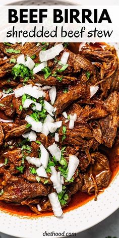 beef birra shredded with onions and parsley in a white bowl on top of a table