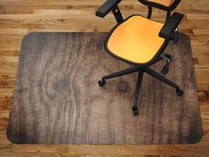 an office chair sitting on top of a wooden floor next to a computer mouse pad