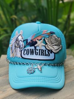 Who doesn't love cowgirls? Cody Johnson's Long Live Cowgirls was the inspiration for this hat! Turquoise Cowgirl patch in center with cream/tan horse, ivory rose, multi colored feather and dark blue/ivory star patches with a silver hat chain that has a turquoise blossom & silver steer head charms accenting it.   5 panel foam front, adjustable snap back, breathable mesh body for coolness. Hat chain is detachable and has lobster claw clasps. One of a kind hat. Great hat for the cowgirl you know, c Trendy Blue Hats For Festival, Trendy Blue Hat For Festival, Trendy Adjustable Baseball Cap For Country Events, Fun Snapback Hat For Country Events, Trendy Baseball Cap For Country Events, Fun Adjustable Mini Hats For Rodeo, Trendy Adjustable Snapback Hat For Country Events, Cute Festival Hats One Size Fits Most, Trendy Adjustable Baseball Cap For Rodeo